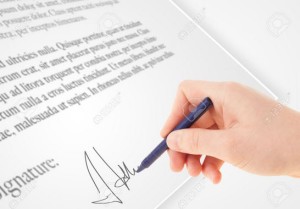 Hand writing personal signature on a legal paper